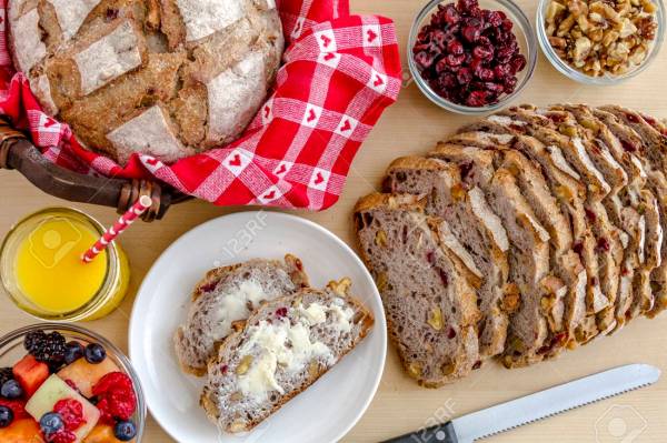 37050044-walnut-and-cranberry-whole-grain-bread-sitting-on-plate-with-butter-fruit-and-orange-juice-from-abov.jpg